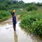 Miracle, age 9 bathing at a pond close to her house