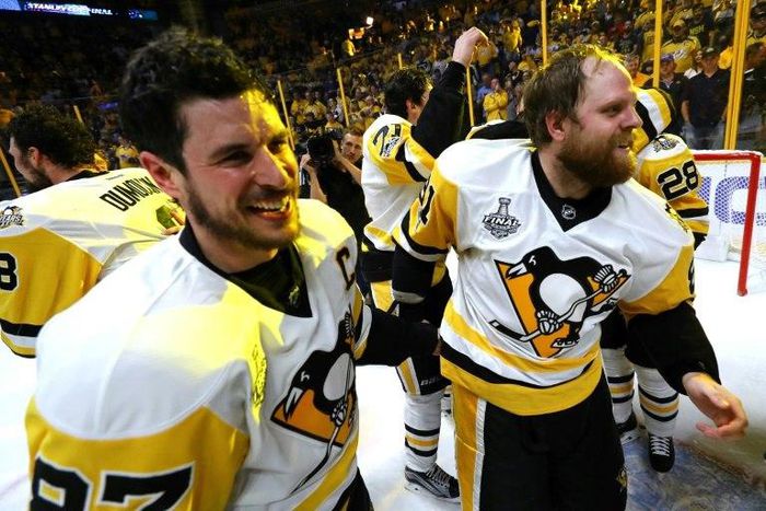 Sidney Crosby of the Pittsburgh Penguins celebrates with teammate Phil Kessel after defeating the Nashville Predators in Game Six of the 2017 NHL Stanley Cup Finals, at the Bridgestone Arena in Nashville, Tennessee, on June 11