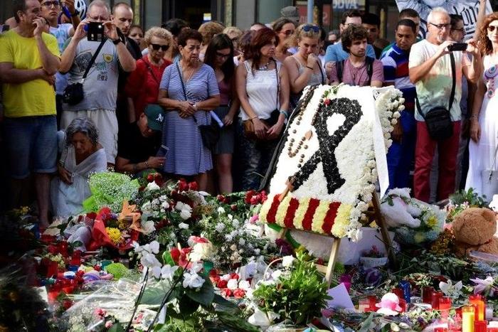 Flowers and candles are placed on Las Ramblas boulevard in Barcelona in tribute to the victims of the twin attacks in Spain