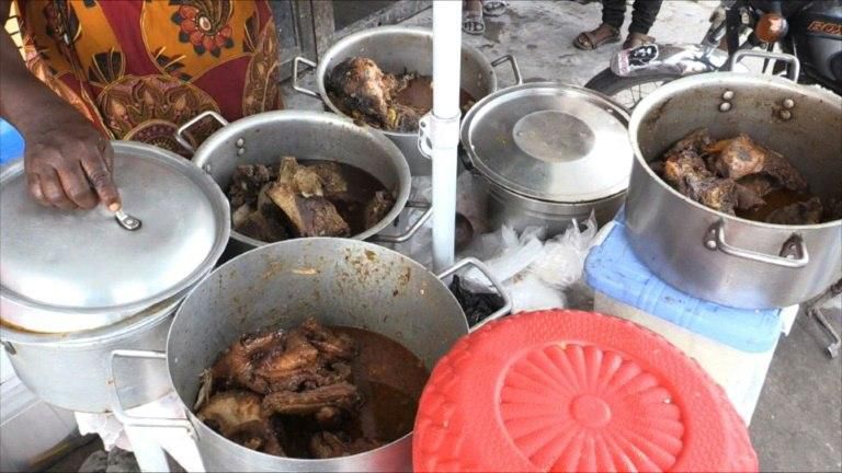 A 'malewa' or street food sellers displays chicken stew at her stall in DR Congo's capital Kinshasa on February 12, 2017