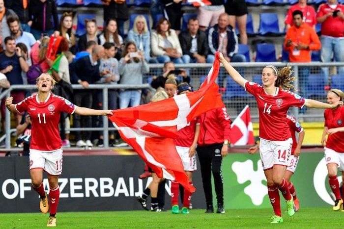 Denmark's players celebrate after winning the UEFA Women’s Euro 2017 football tournament semi-final match between Denmark and Austria at the Rat Verlegh Stadium, in Breda, on August 3, 2017