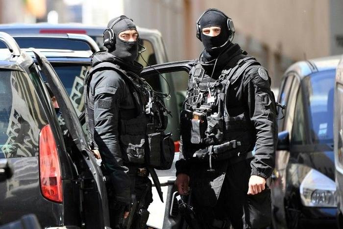 Members of the French RAID police search the home of one of the two men arrested in Marseille on April 18, 2017 in Marseille, on suspicion of planning an "imminent" attack plot just days from the presidential polls