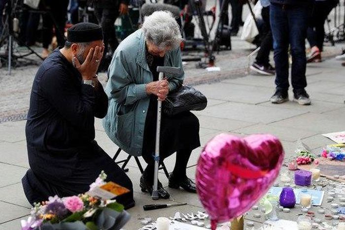 Two grieving people in Manchester