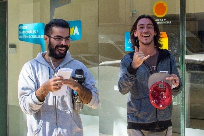 Two men express joy after registering as marijuana's buyers in Montevideo