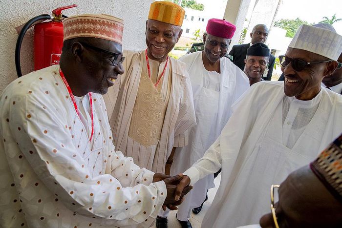 President Muhammadu Buhari shakes hands with Senator Ahmed Makarfi of the PDP during a political meeting