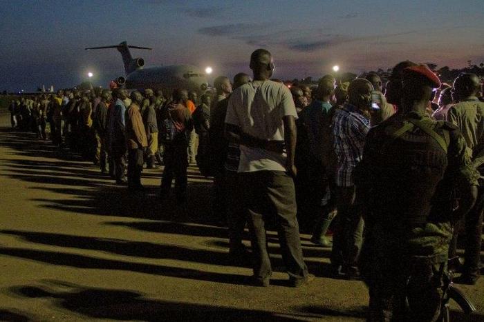 Members of the M23 rebel group waiting at a Ugandan army air base to be flown to the Democratic Republic of Congo in 2014