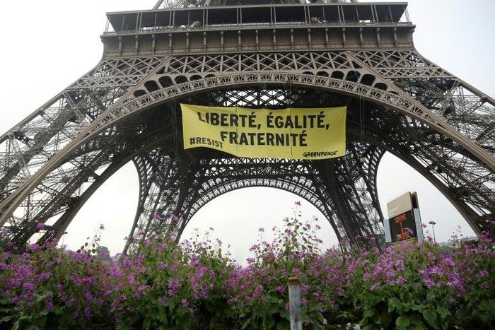A Greenpeace banner at the Eiffel Tower recalls the values of the French republic -- "liberty, equality, fraternity" -- in protest against the far-right National Front of Marine Le Pen, who faces centrist Emmanuel Macron in Sunday's election