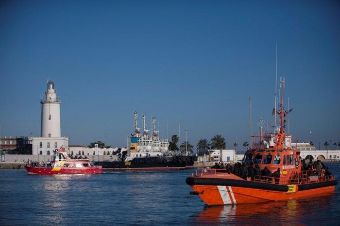 Would-be immigrants stand on a coastguard vessel as they arrive in Spain March 2, 2017, after an inflatable boat carrying 52 people was rescued by the Spanish coastguard, some of the more than 8,000 migrants who had arrived in Spain in 2017 by August