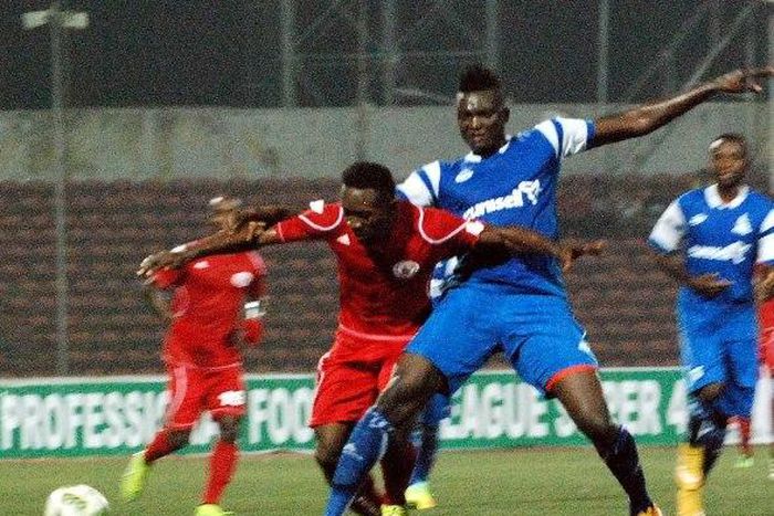 Aliassou Sanou of Rivers United challenges Chisom Egbuchulam of Rangers