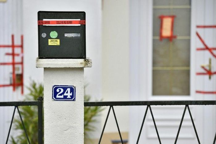 Police sealed displayed on the mail box and the entrance of the house of the Troadec family, the day after the brother in law of the father, Hubert Caouissin confessed the killing of all four members of the family