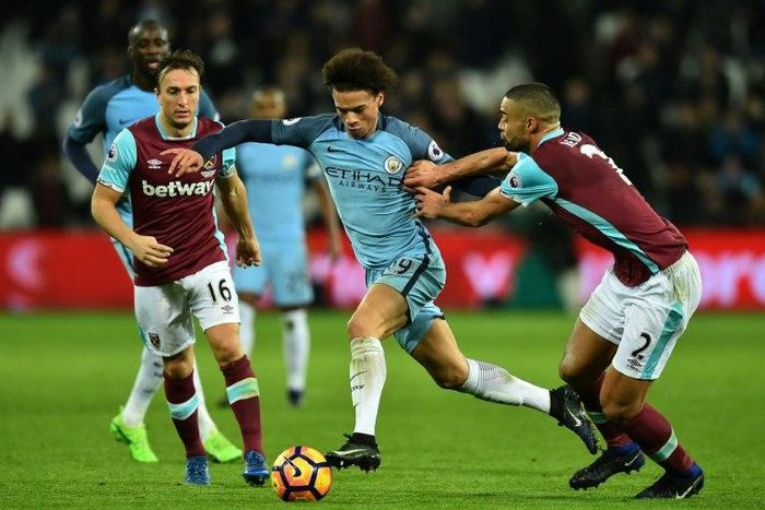 Manchester City's midfielder Leroy Sane (C) vies with West Ham United's midfielder Mark Noble (L) and defender Winston Reid during the English Premier League football match between February 1, 2017