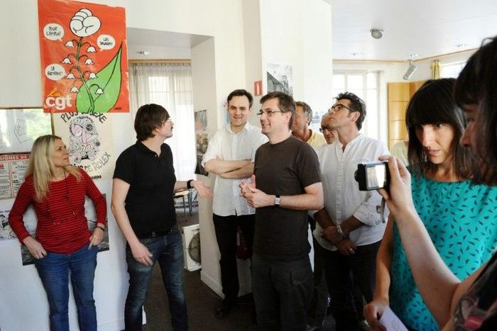 File picture shows cartoonist Catherine Meurisse (R) at an editorial meeting at the Paris office of French satirical magazine Charlie Hebdo