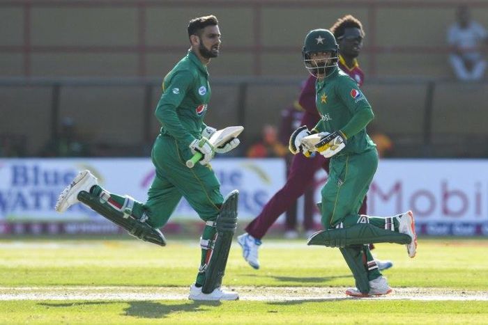 Shoaib Malik (L) and Mohammad Hafeez (C) of Pakistan 100 run partnership during the 3rd and final ODI match between West Indies and Pakistan at Guyana National Stadium, Providence, Guyana, April 11, 2017.The fielder is Chadwick Walton (R) of West Indie...