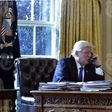President Donald Trump speaks on the phone with Russia's President Vladimir Putin from the Oval Office of the White House on January 28, 2017, in Washington.