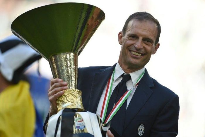 Juventus' coach Massimiliano Allegri poses with the trophy after winning the scudetto at the Juventus Stadium in Turin on May 21, 2017