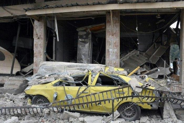 A May 23, 2017 picture from Syria's official SANA news agency shows the aftermath of a reported car bombing near the Al-Zahraa neighbourhood of Homs city