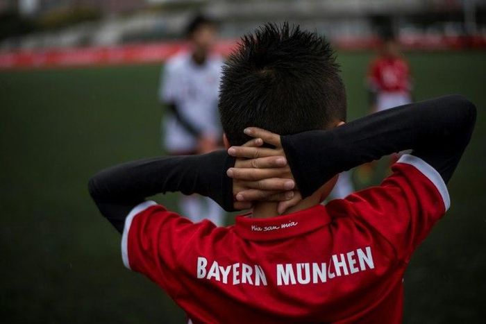 A Chinese boy takes part in a training session after the opening ceremony of Bayern Munich's office in Shanghai on March 22, 2017