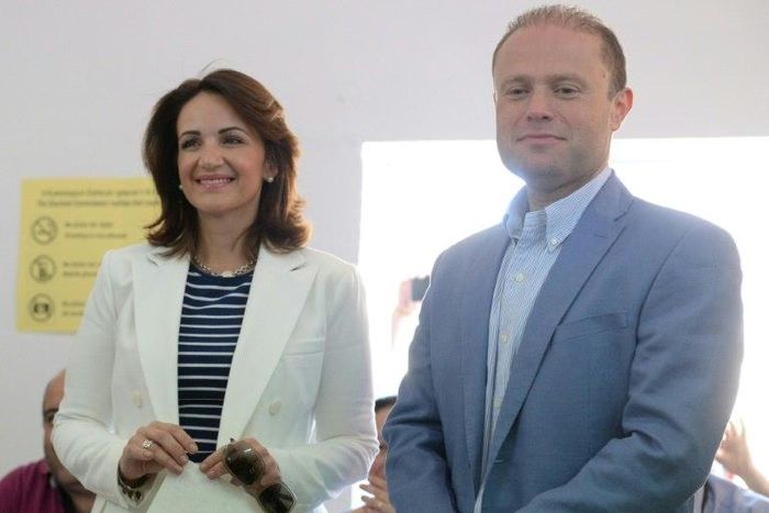 Malta's Prime Minister Joseph Muscat and his wife Michelle Muscat prepare to vote at a polling station in his home town of Burmarrad on June 3, 2017