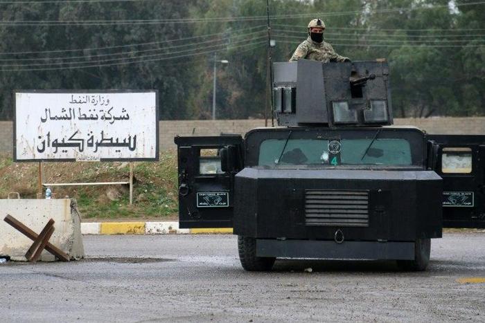 Masked Kurdish forces loyal to the Patriotic Union of Kurdistan (PUK) stand guard at the North Oil Company headquarters in the northern Kurdish-controlled city of Kirkuk on March 2, 2017