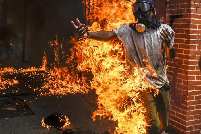A demonstrator catches fire during clashes in a Caracas protest