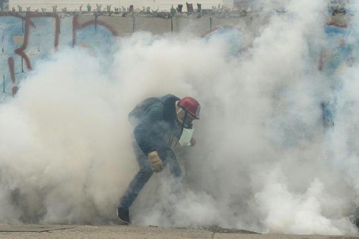 Riot police and pro-government vigilantes fought running battles in Caracas with protesters demanding the ouster of President Nicolas Maduro