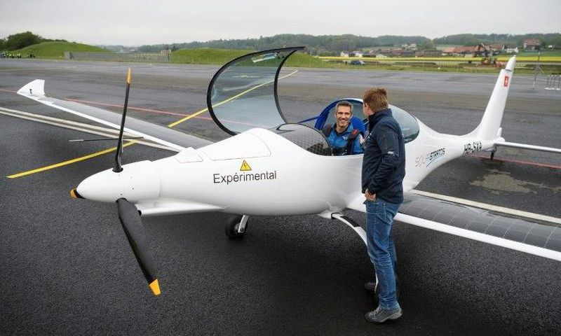 Raphael Domjan, who initiated the SolarStratos project, shakes hands with pilot Damian Hischier after the first test flight in Payerne, Switzerland