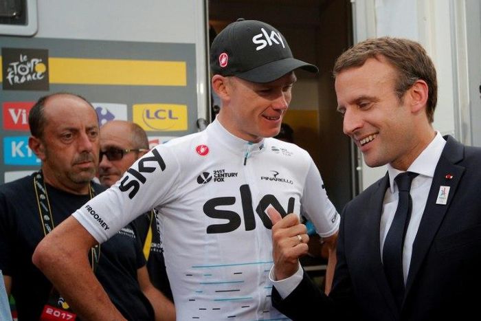 French President Emmanuel Macron (R) talks to overall leader, Britain's Chris Froome, after the 183km 17th stage of the 104th edition of the Tour de France cycling race, in Serre-Chevalier, on July 19, 2017
