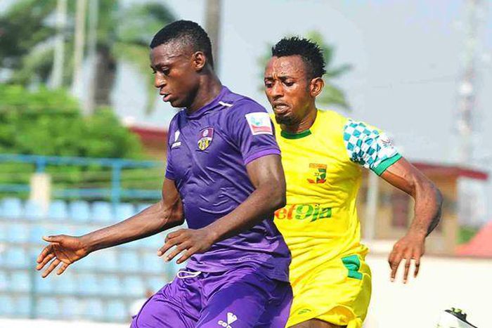 Stephen Odey, the league's highest goal scorer shielding the ball from a Plateau United player