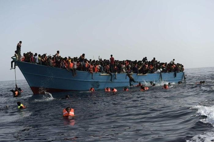 Migrants wait to be rescued by members of Proactiva Open Arms NGO in the Mediterranean Sea, some 12 nautical miles north of Libya, on October 4, 2016