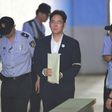Lee Jae-Yong, the vice-chairman of Samsung Electronics, is escorted by prison guards as he arrives in court