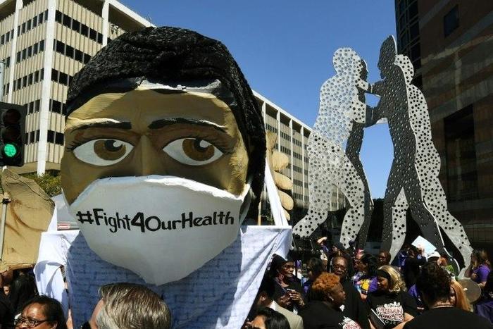 Protesters march outside the Federal Building during a "Save the Affordable Care Act" (Obamacare) rally in Los Angeles