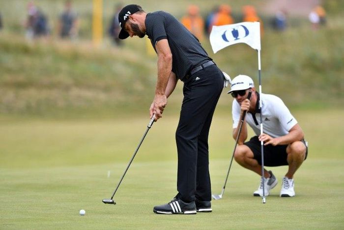US golfer Dustin Johnson putts on the 14th green during a practice round at Royal Birkdale golf course near Southport, north-west England, on July 19, 2017, ahead of the 146th British Open