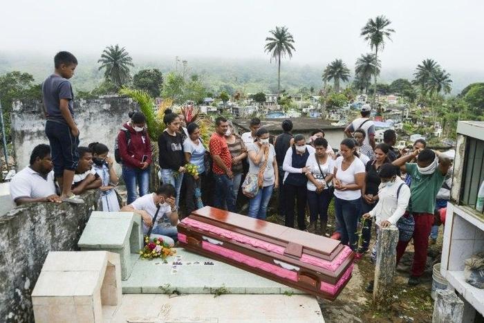 Relatives and friends of Deisy Rosero, 26, pray during her funeral at a cemetery in Mocoa, Putumayo department, southern Colombia on April 3, 2017