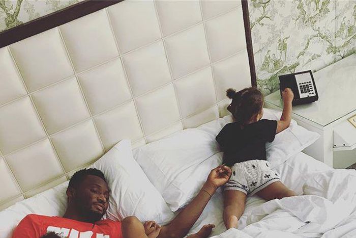 Mike Obi with his twin daughters