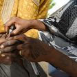 Health worker tries to immunise a child during a vaccination campaign against polio at Hotoro-Kudu, Nassarawa district of Kano in northwest Nigeria, on April 22, 2017