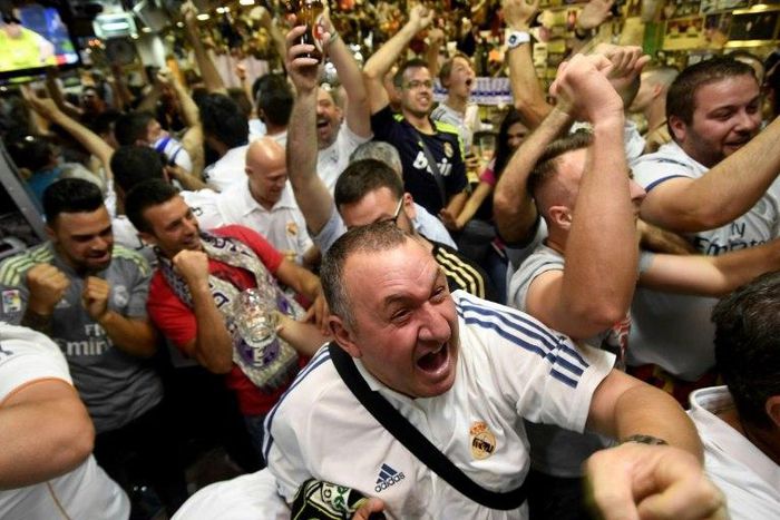 Real Madrid's supporters celebrate at a bar in Madrid on June 3, 2017