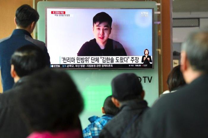 South Koreans watch a TV broadcast showing video footage of a man who claims to be Kim Han-Sol, a nephew of North Korea's leader Kim Jong-Un, at a railway station in Seoul, on March 8, 2017