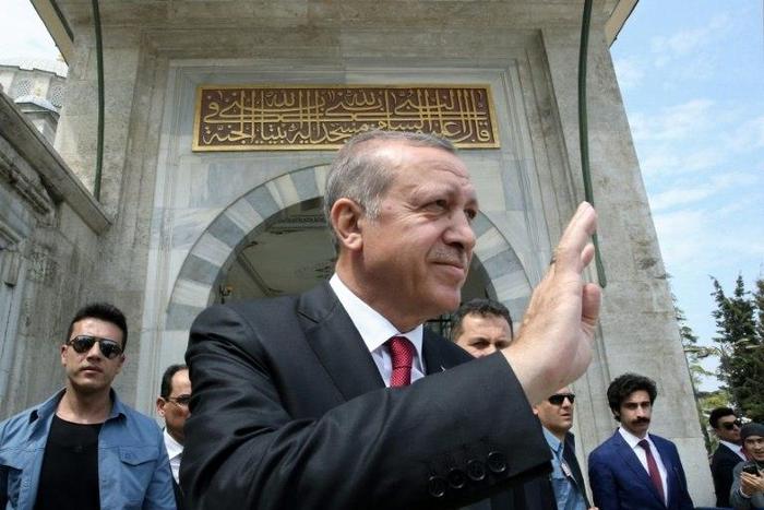 Turkish President Recep Tayyip Erdogan (C) greeting his supporters during a visit to the Ottoman Fatih Sultan Mehmet's tomb in Istanbul, a day after his victory in a national referendum on April 17, 2017