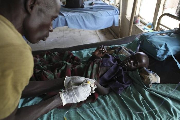 Health worker attending to a malaria patient - illustrative photo.