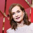 Nominee for best actress in "Elle", Isabelle Huppert oozed glamour in her glittering long-sleeved, champagne floor-length Armani gown with a demure neckline
