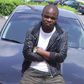 Dagrin sitting on his Nissam Maxima