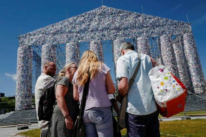 People pause in front of the "Parthenon of Books" by Argentinian artist Marta Minujin, at the Documenta 14 art exhibition in Kassel