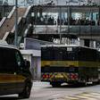 Bystanders watch as a prison van (C) transporting British banker Rurik Jutting, accused of the murders of two Indonesian women, leaves the High Court escorted by a police convoy in Hong Kong in the city's biggest murder case for years