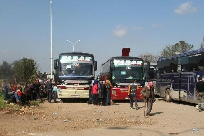 Syrians wait in rebel-held Rashidin, west of Aleppo city, following delays in evacuating them, on April 15, 2017