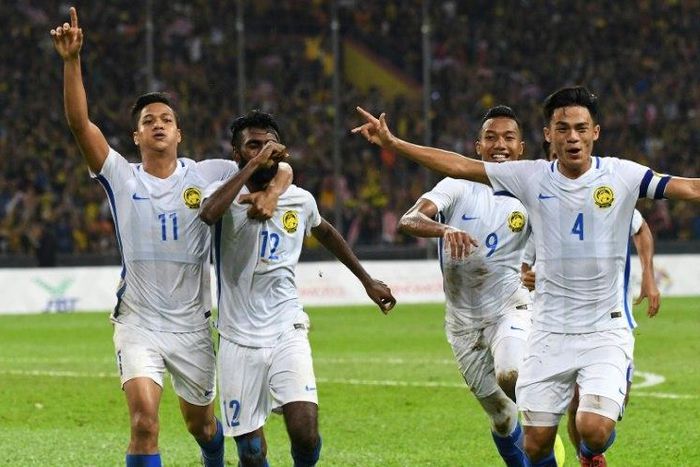 Malaysian players celebrate after scoring winning goal against Indonesia during their 29th Southeast Asian Games (SEA Games) football semi-final match, at Shah Alam Stadium outside Kuala Lumpur, on August 26, 2017