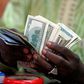 A bureau de change operator counts U.S. currency notes in Abuja, March 12, 2015.  REUTERS/Afolabi Sotunde/File Photo