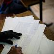 An election officials checks a list of voters names in Democratic Republic of Congo