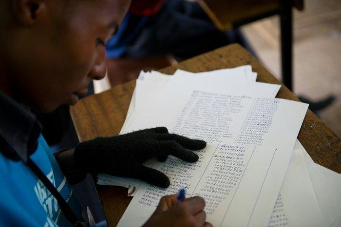 An election officials checks a list of voters names in Democratic Republic of Congo