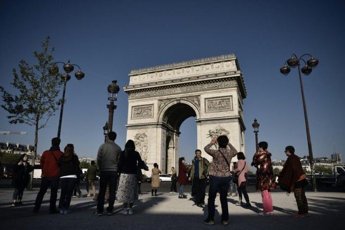 Tourists returned to the Champs Elysees on Friday, with many vowing that the killing of a policeman on the world-famous avenue would not stop them from coming