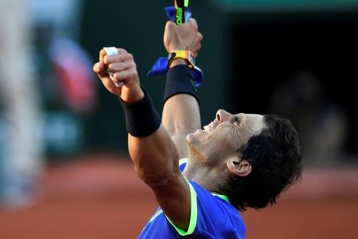 Spain's Rafael Nadal celebrates after winning his semifinal tennis match against Austria's Dominic Thiem at the Roland Garros 2017 French Open on June 9, 2017 in Paris